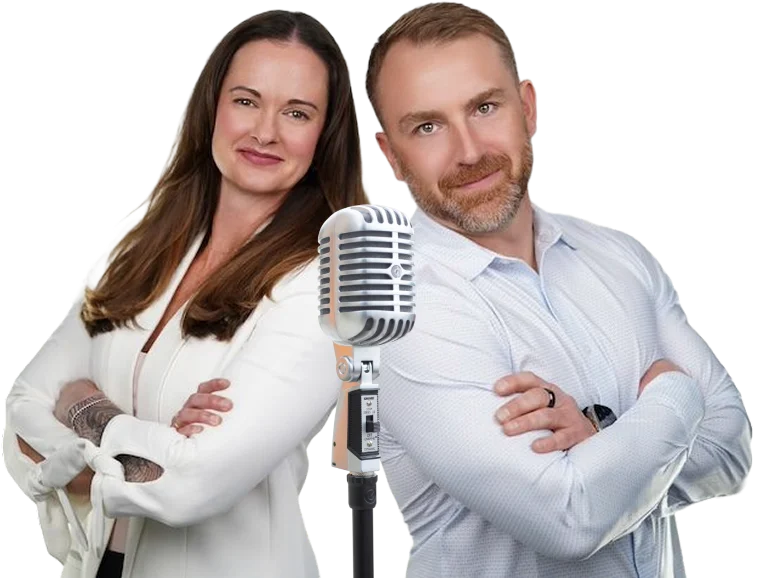 as-seen-on-bg (2) Two people in business attire stand with arms crossed, smiling, next to a large vintage-style microphone.